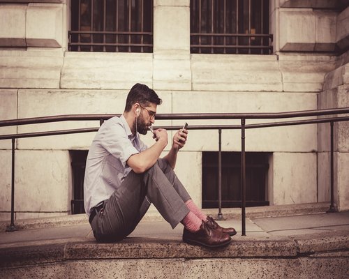 Person holding a smartphone carefully